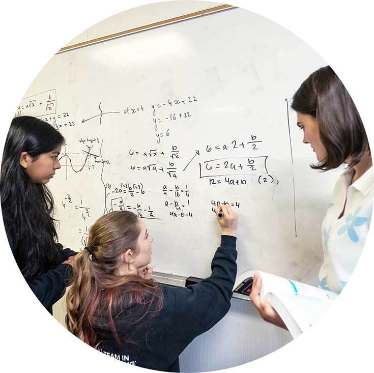 SVI students and teacher working at a whiteboard